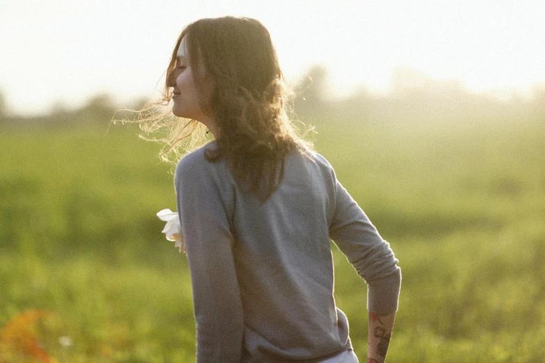 there is a woman standing in a field