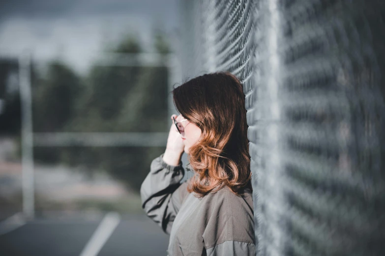 there is a woman leaning up against a wall