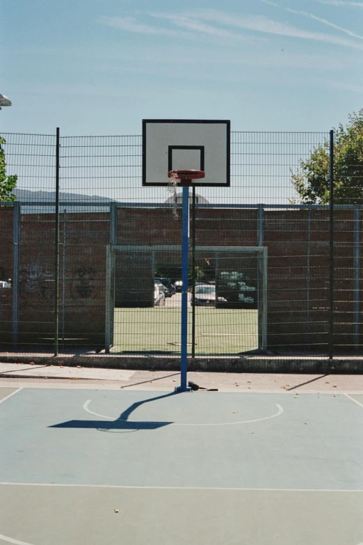 a basketball hoop in a court near some wire