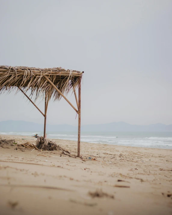 a bamboo gazebo at the beach on a cloudy day