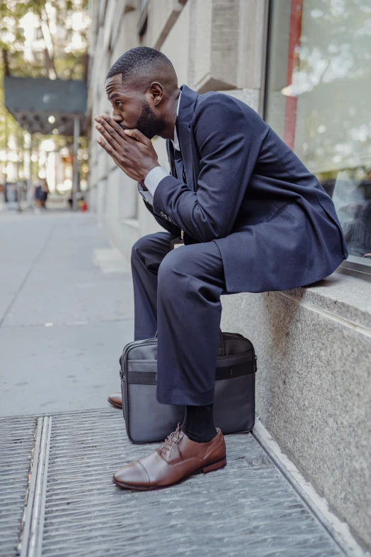 a man sitting on a street corner looking away