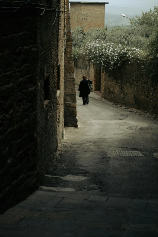 a person walking in an alleyway between buildings