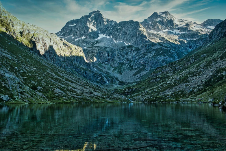 a mountain range in the background with water and trees on it