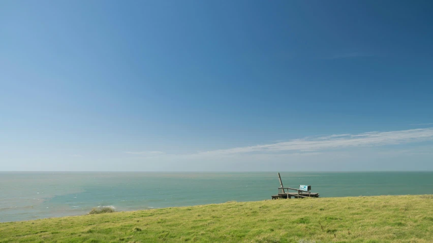 an empty boat is moored on top of a hill