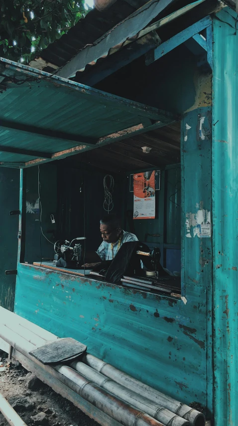 a man sits inside of a boat in the water