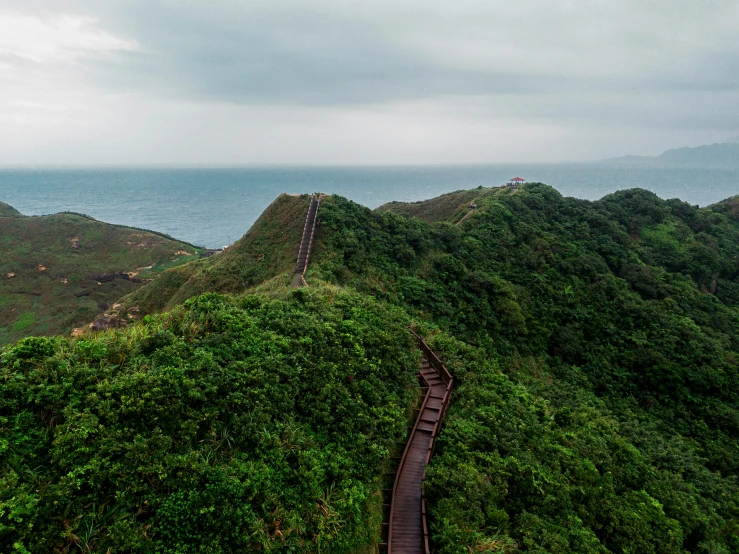 an elevated train track going up a steep hill near the ocean