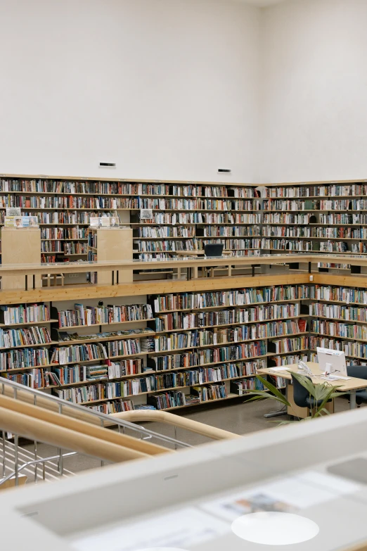 an empty liry with tables, chairs and book shelves