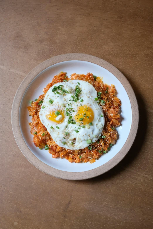 a plate of eggs on a bed of noodles