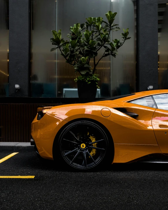 a bright orange sports car sits parked on the street