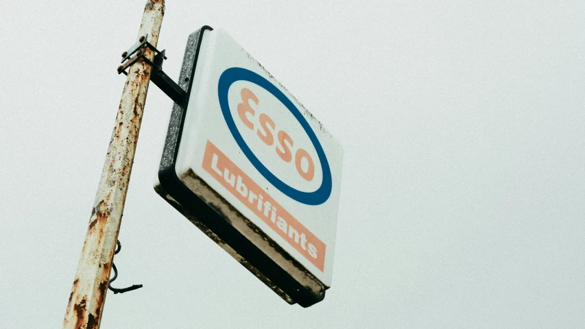 a close up of a sign on a wooden pole