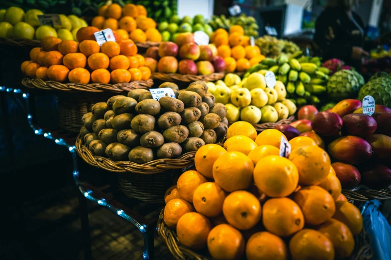 several different fruits on display in baskets