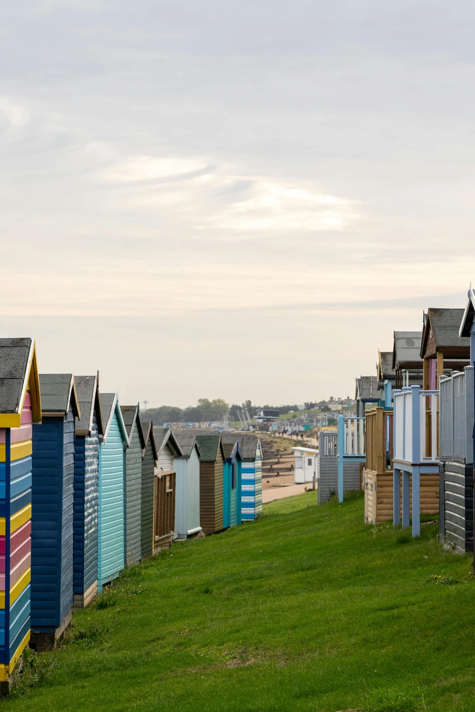 a row of colorful beach huts are lined up