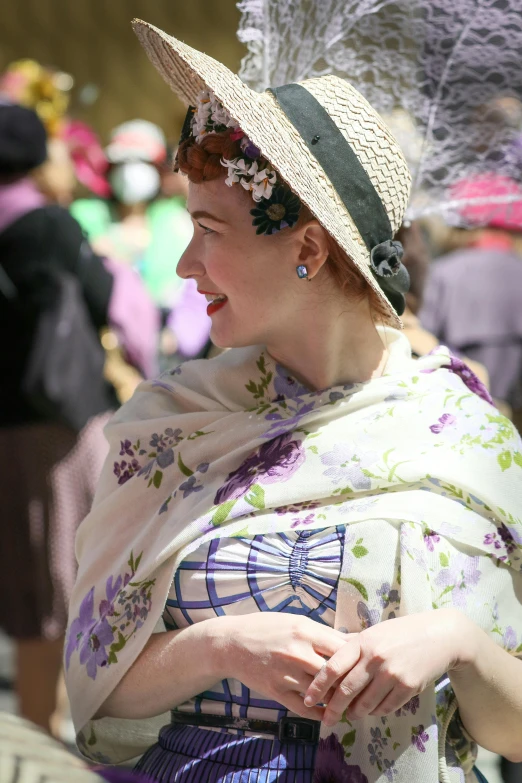 a woman in a hat looking down at soing