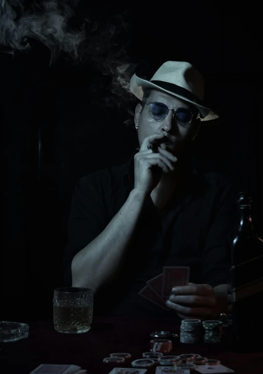 a man in a hat smokes a cigarette