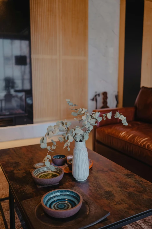 a glass vase filled with flowers sitting on a table