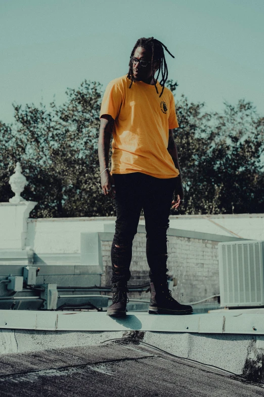 a person is standing on top of a ledge wearing skateboards