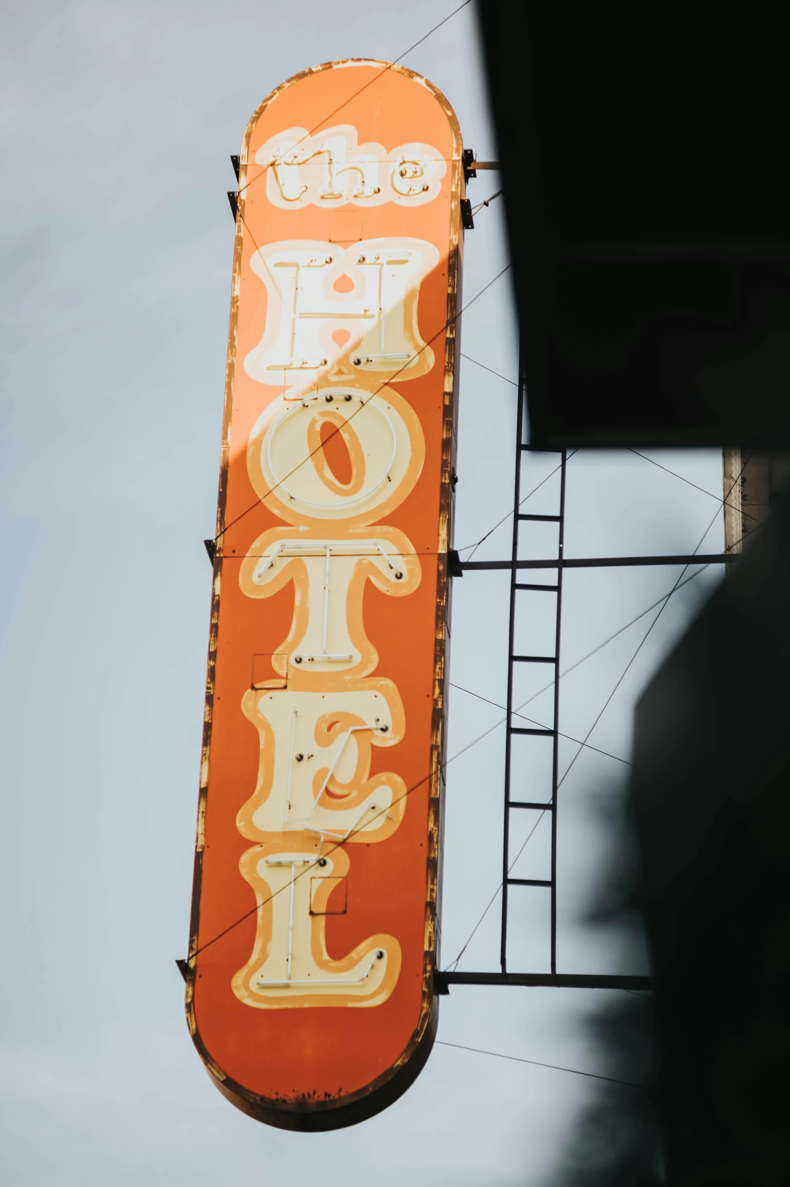 the top of a building and a neon sign that says motel