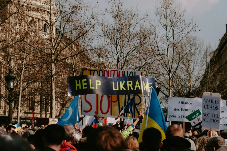 a large group of people holding signs and signs