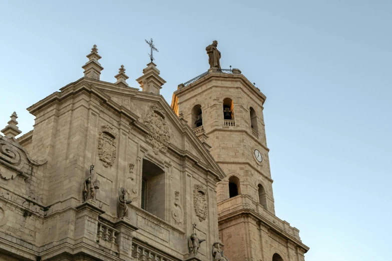 the steeple and tower of a church with two clocks