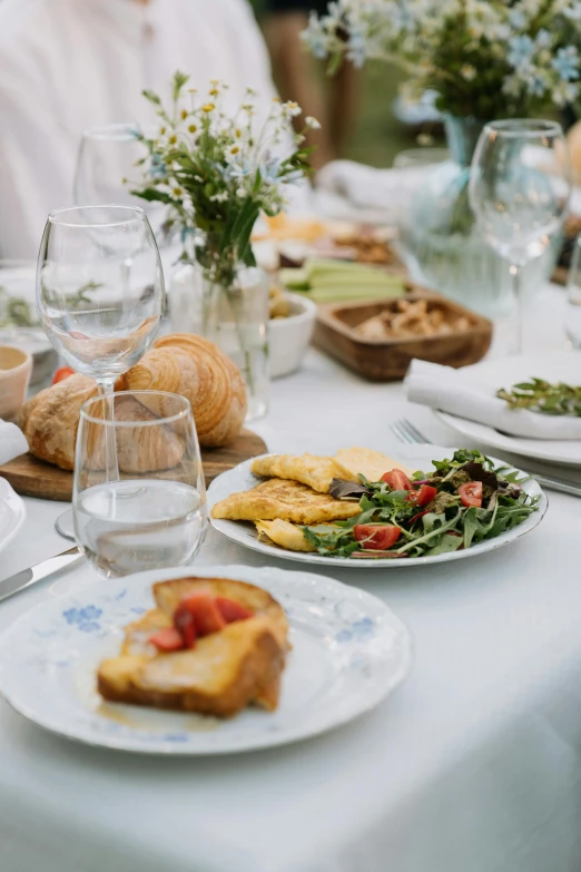 there is plates of food at a dining table