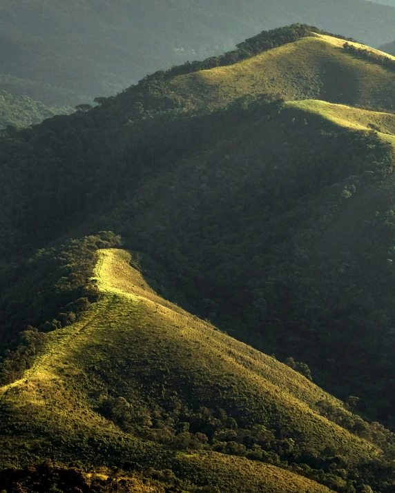 mountains rise above the landscape while the sun shines brightly