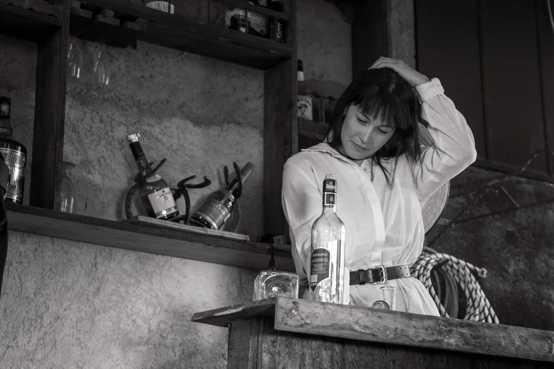 a woman is sitting down behind the counter in the kitchen