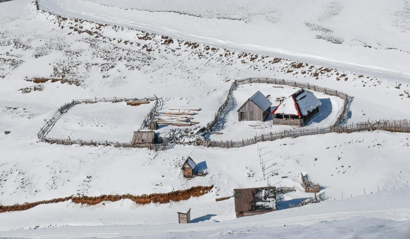 a very pretty snow covered house on top of a hill