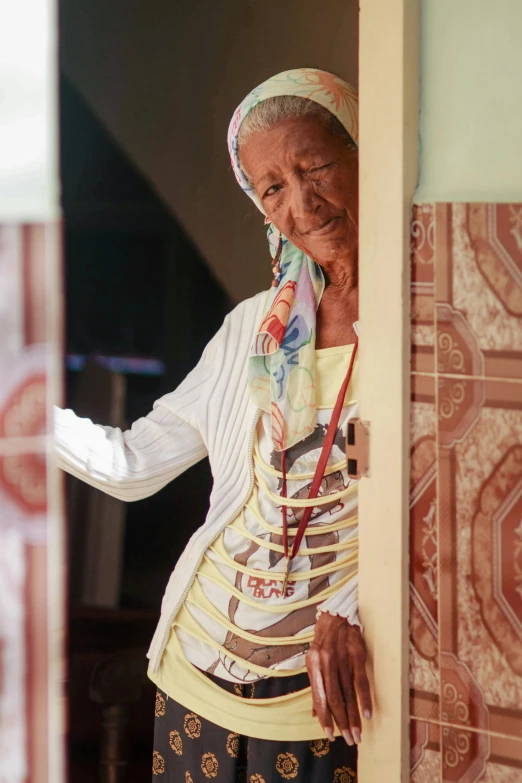 an elderly lady leaning out the window of her home