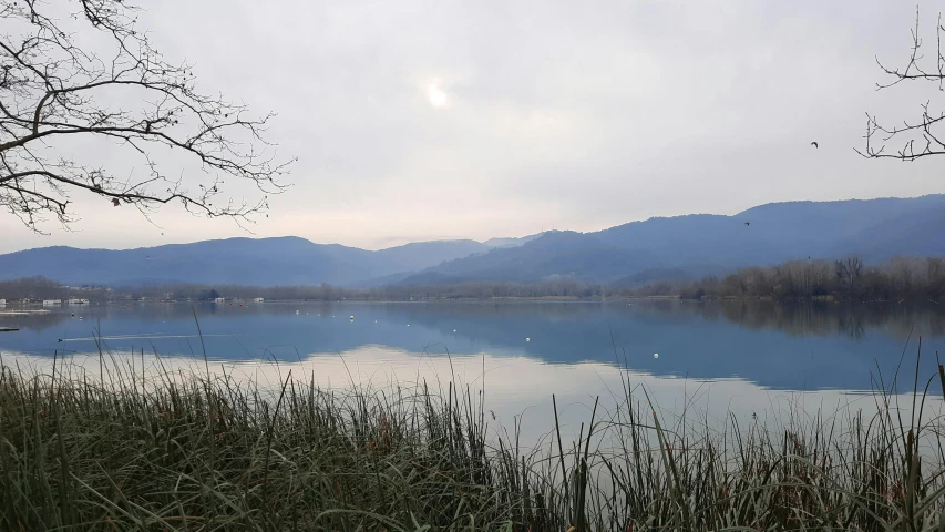 the water near mountains is calm and crystal