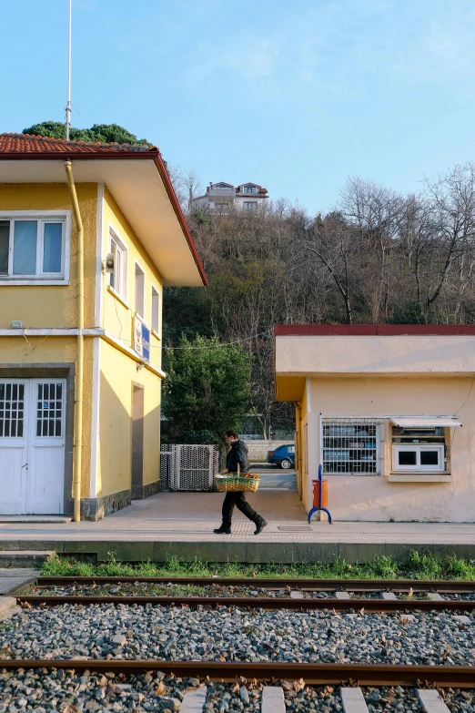 two yellow buildings next to a train track