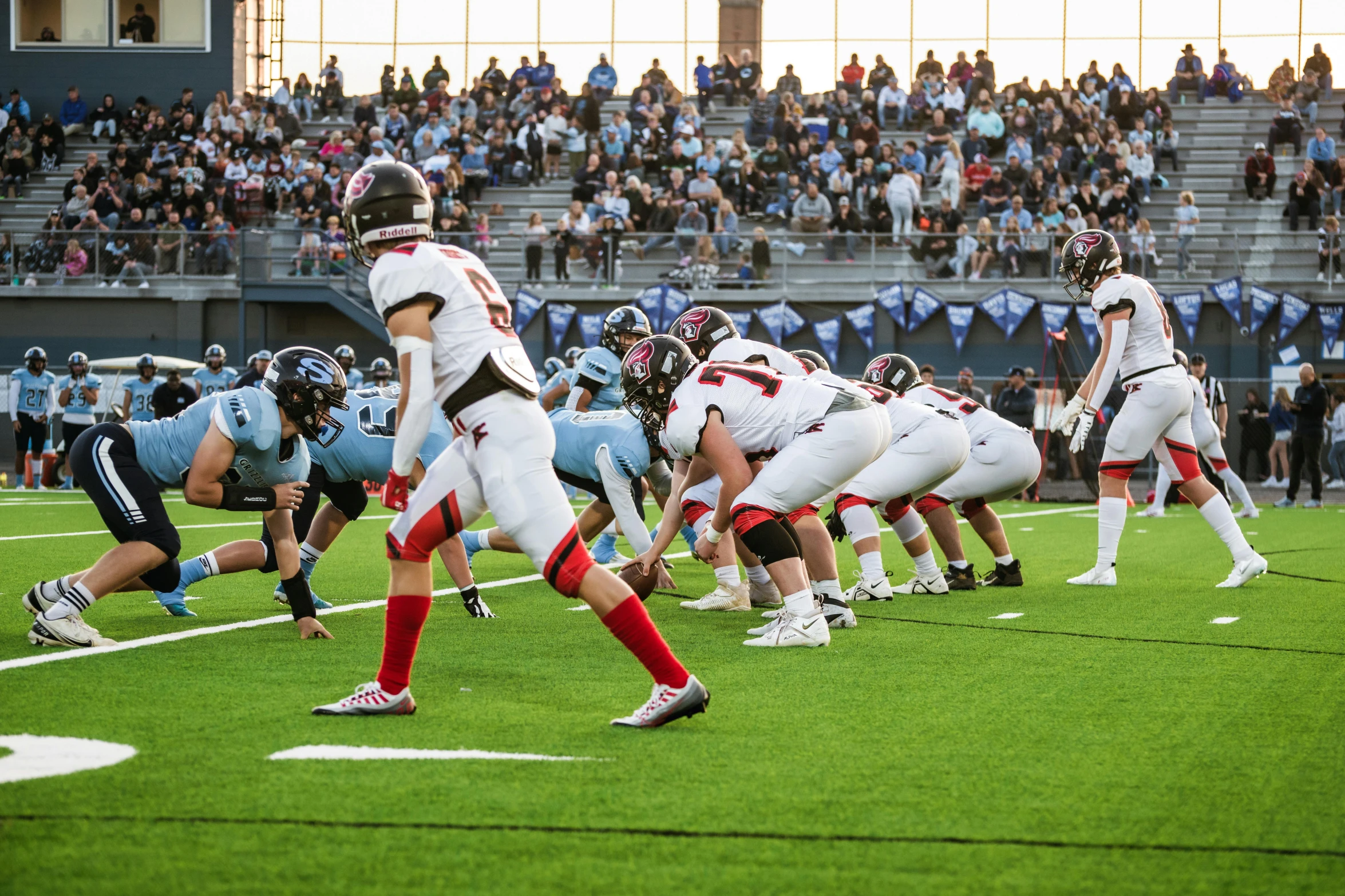 a football game with several players standing on each side