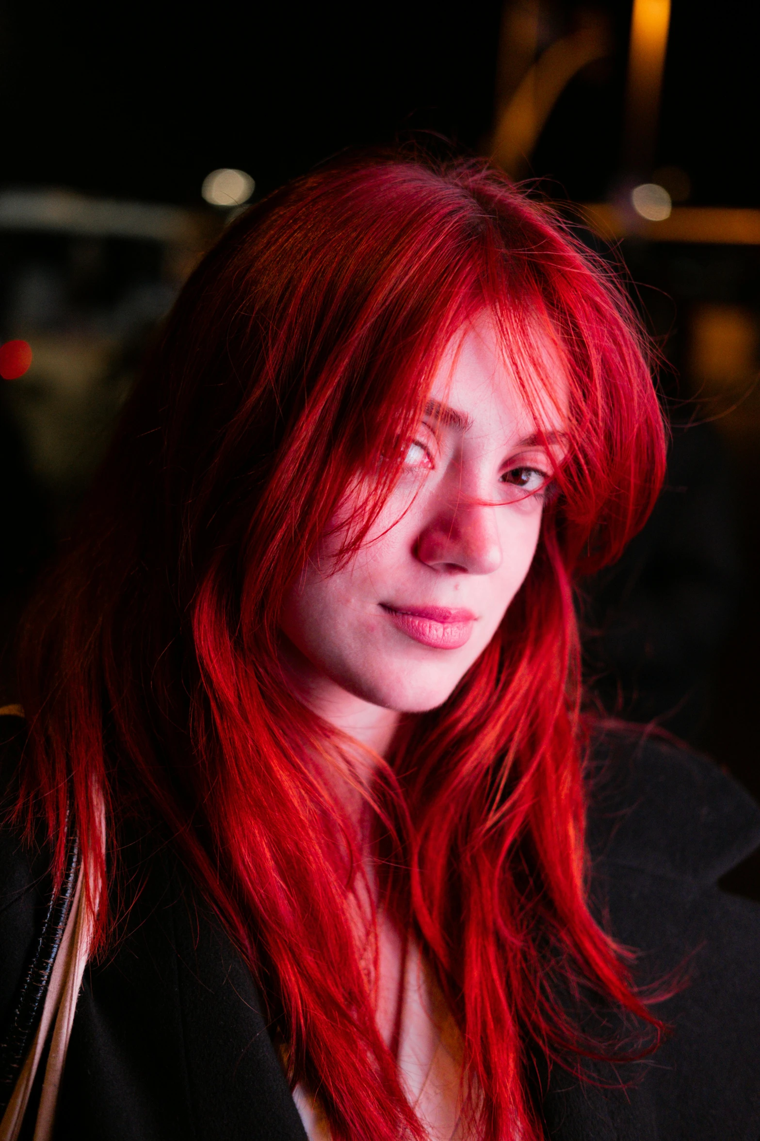 a beautiful woman with long red hair posing for a po