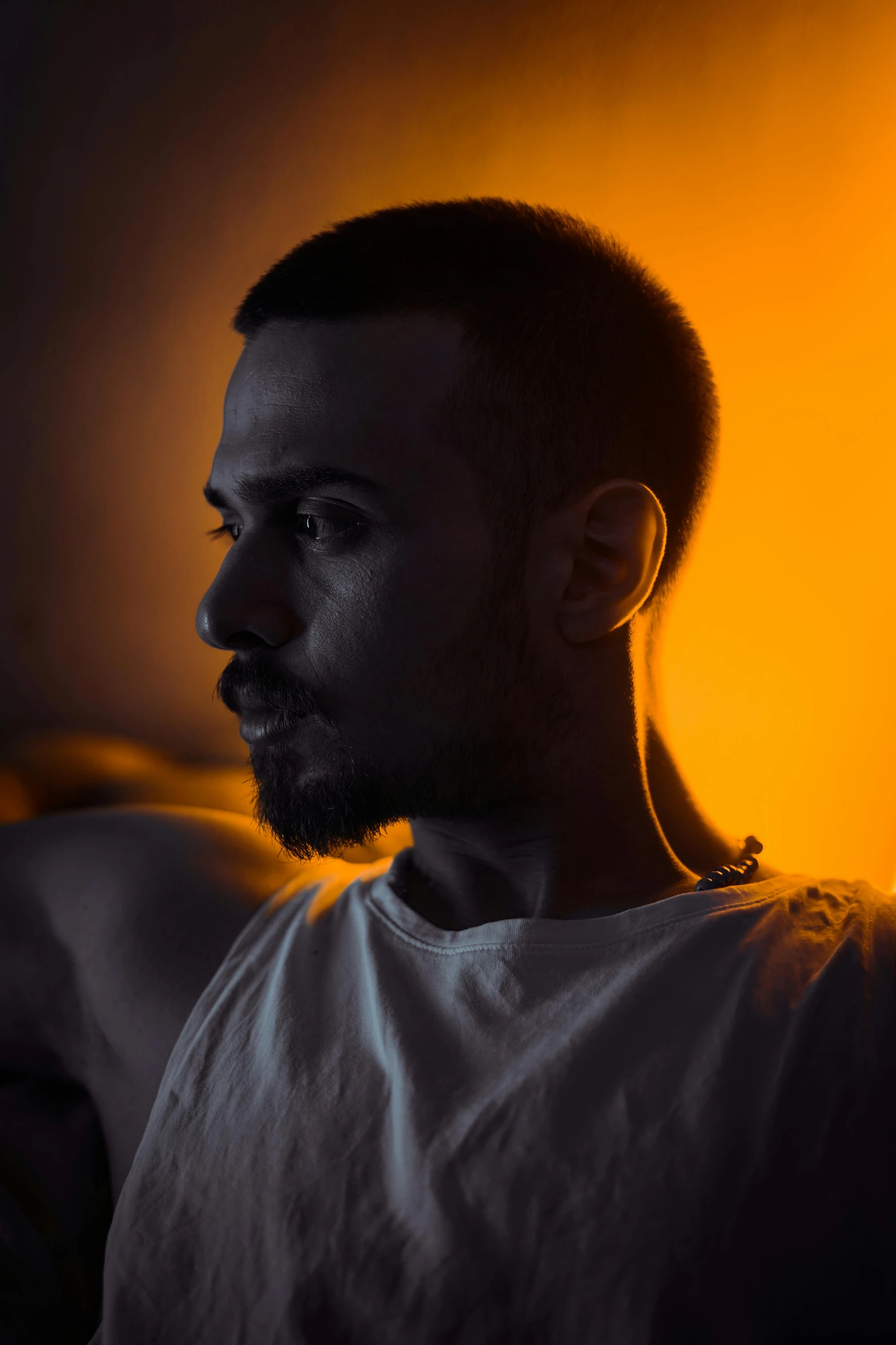 a black man in white shirt staring into the distance