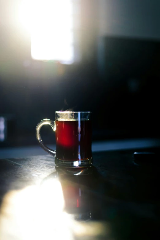 a glass cup with tea in it on a table