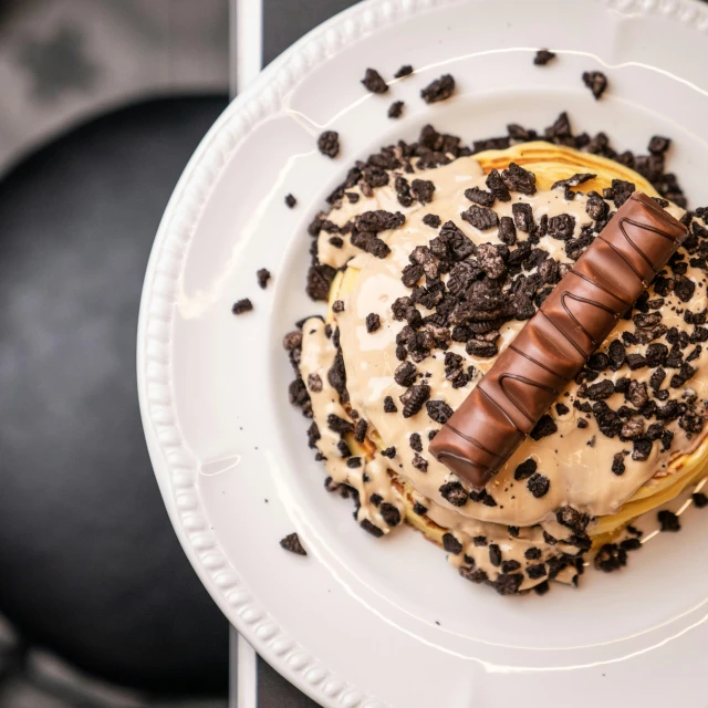 a fancy dessert with chocolate and toppings is on a plate