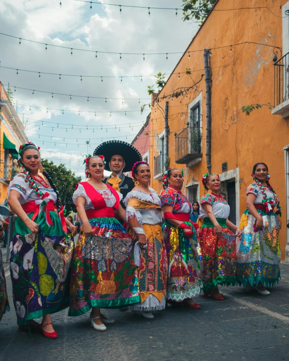 women in traditional clothes walking down a street