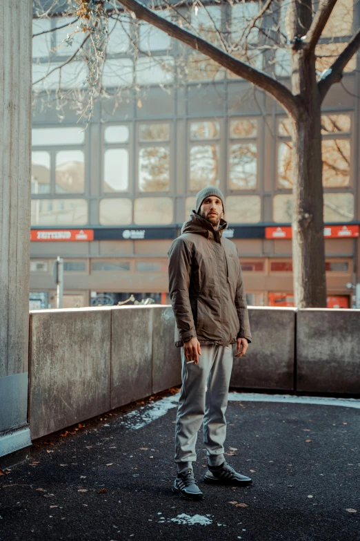 a man standing on the street in a hoodie