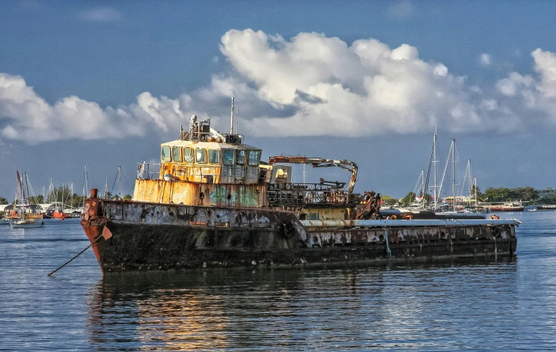 a rusted boat sitting in the water