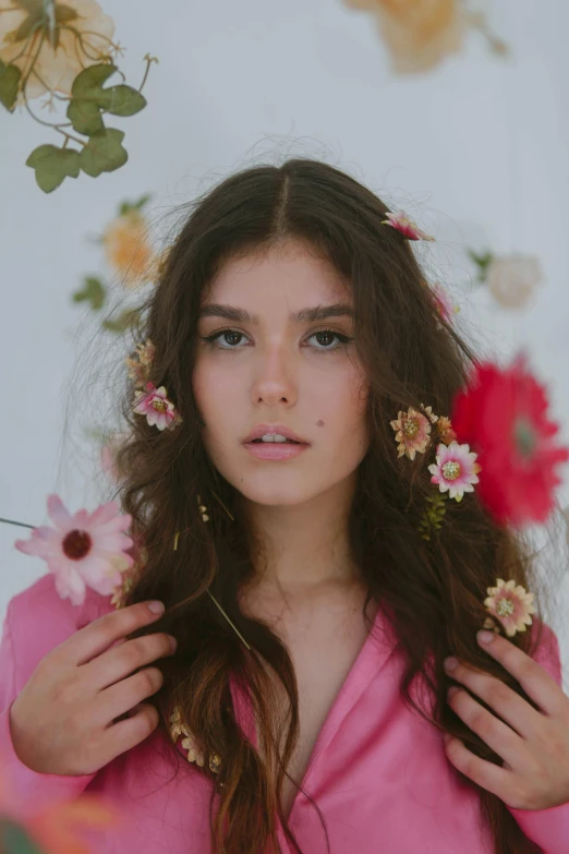 an image of a woman holding flowers near her hair