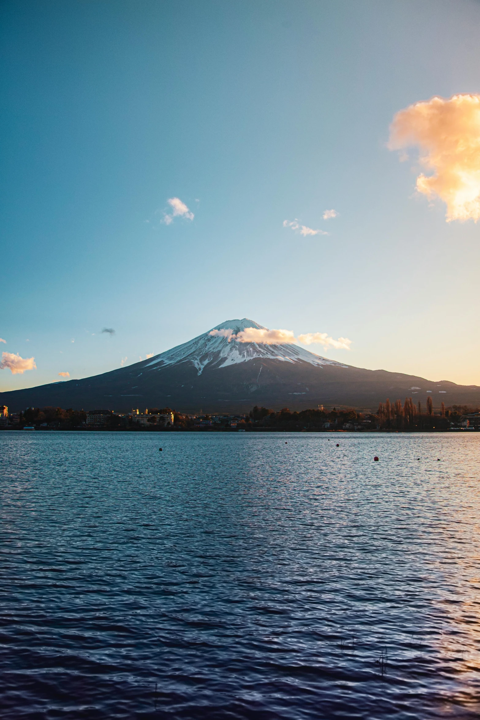 a mountain in the distance is over the water