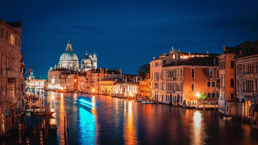 boats floating on water next to some buildings