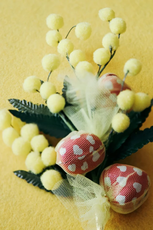 some small red flowers and balls on the ground