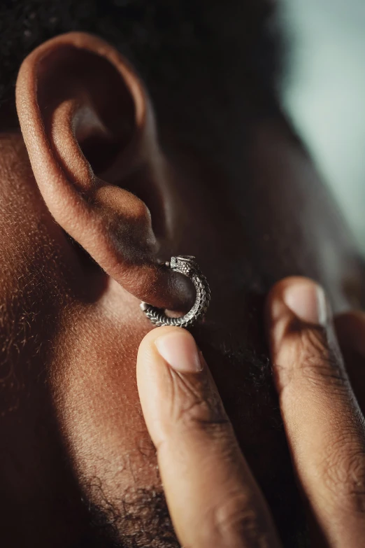 a person wearing a piercing while he's getting his nose pierced