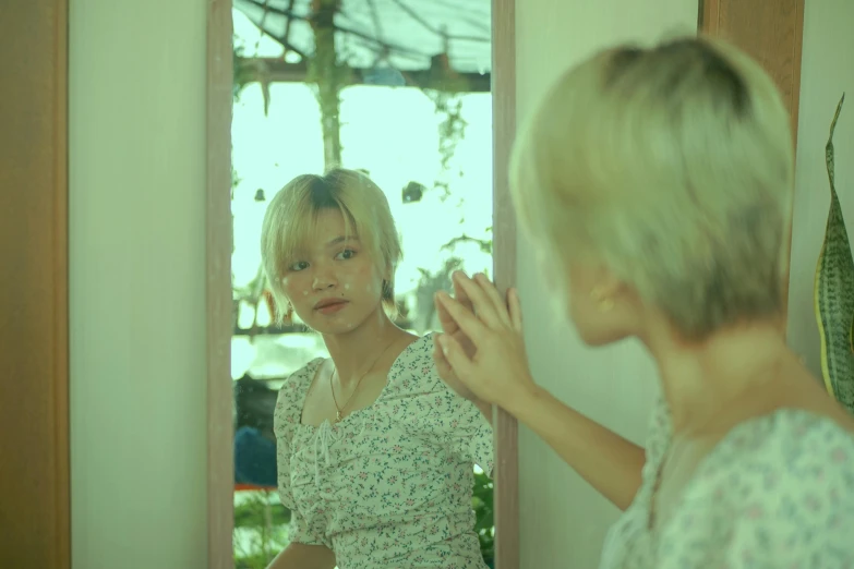 two women standing in front of a mirror