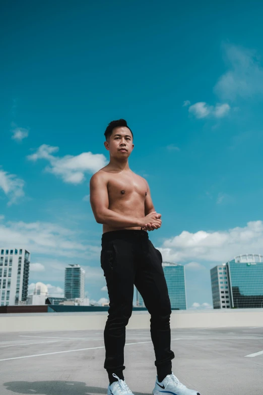 an image of a shirtless man standing outside