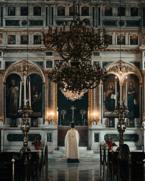 a priest is standing in a large room