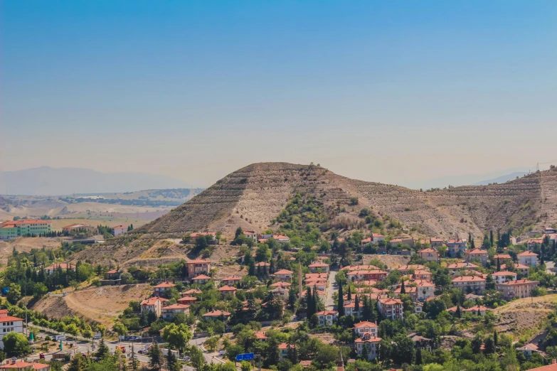 a landscape with hills and houses on it