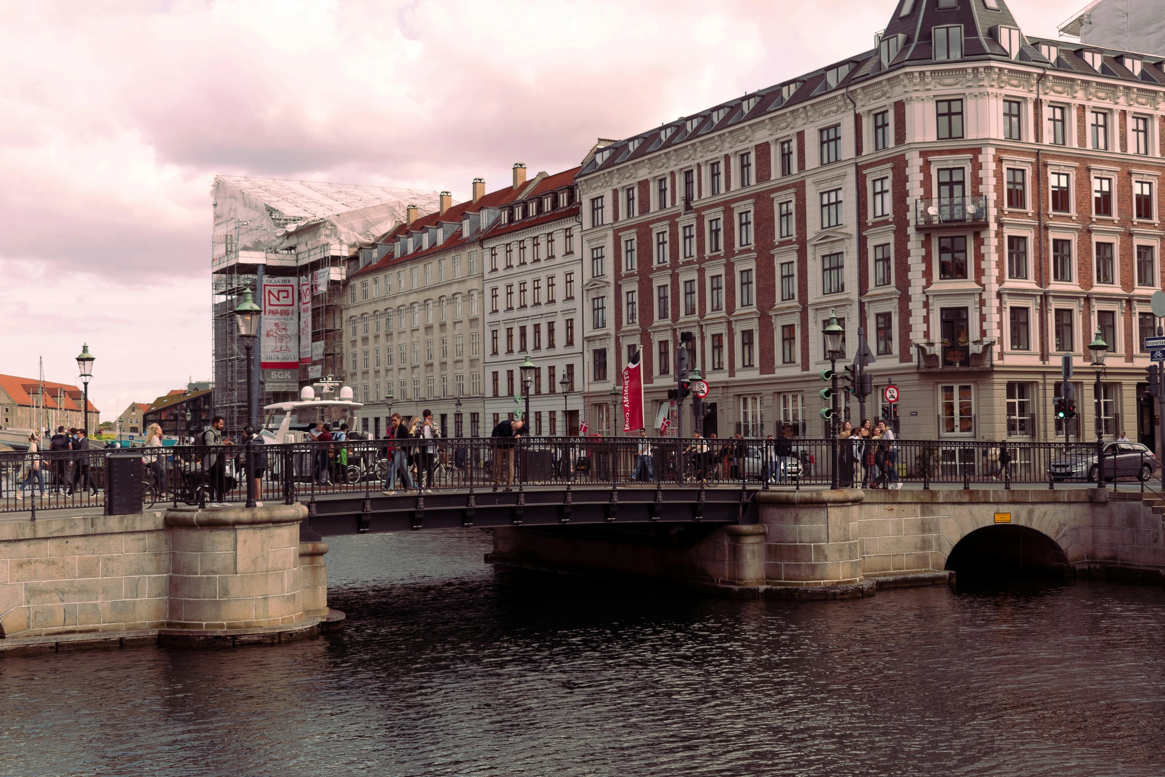 a bridge with people crossing in front of it