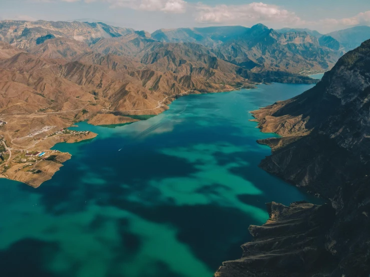 a scenic view looking down at a lake surrounded by mountains