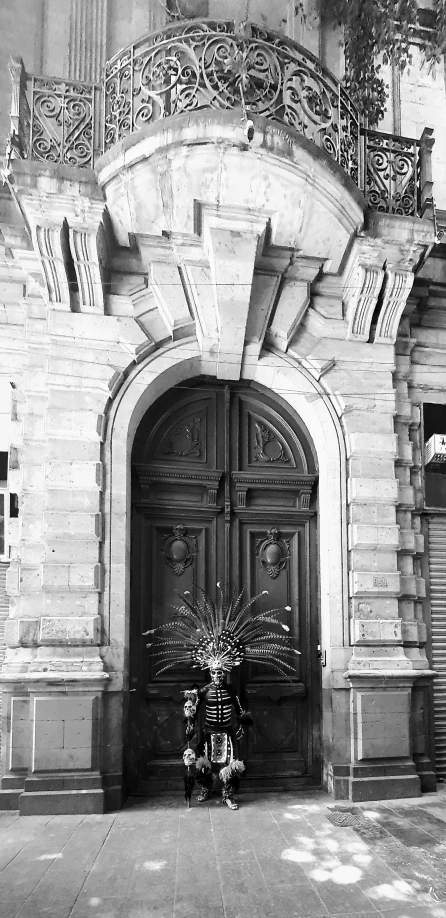 an antique building with ornate iron balconies and carved wooden doors